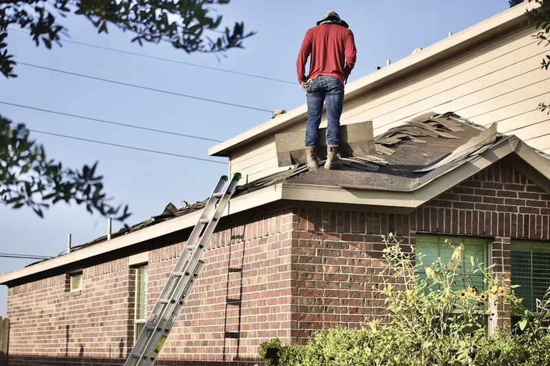 Professional roofer working on a residential roof in Lafayette Hill
